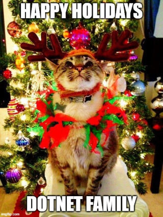 "A Cat in tinsel saying Happy holidays, dotnet family"